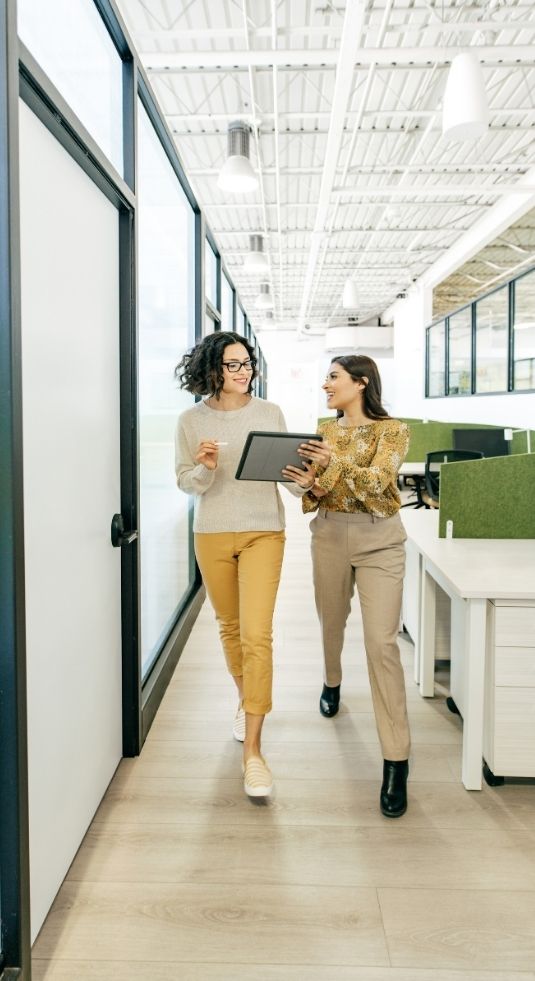 Two women in a nonprofit office walking down the hall in a nonprofit staffing agency