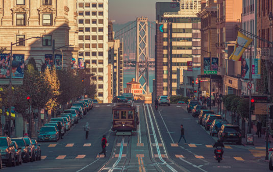 San Francisco Nonprofit Staffing & Recruitment Agency image of downtown San Francisco with cars and trolley