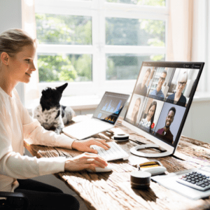 Top Online Courses for Certifications for Tech Jobs image of woman on online call with coworkers at desk with dog
