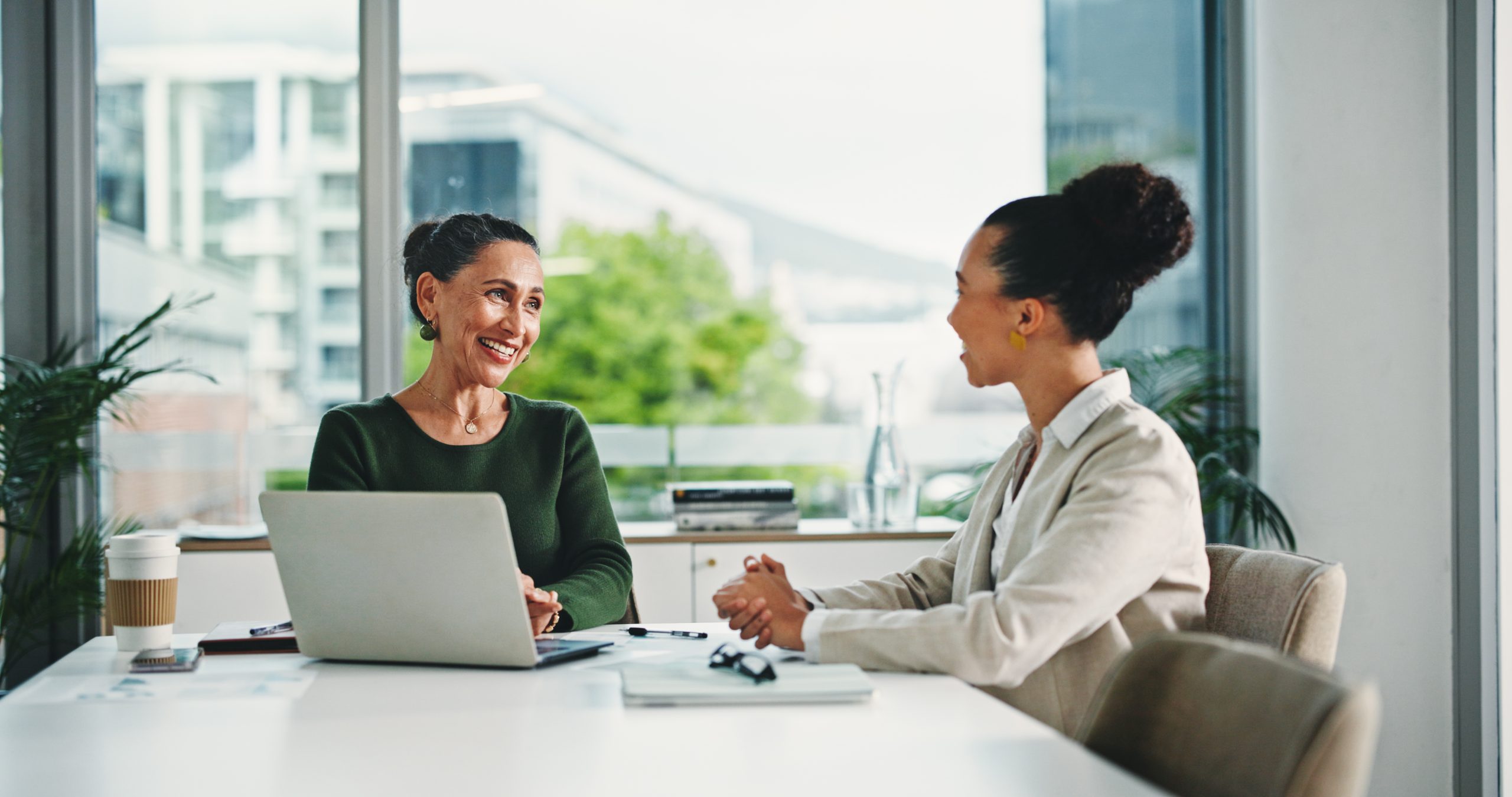Customer service manager coaching a team member during a one-on-one conversation